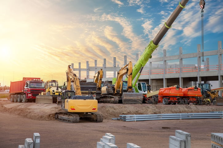 workers at a construction site handling concrete loads and quality control with real-time concrete monitoring in concrete production