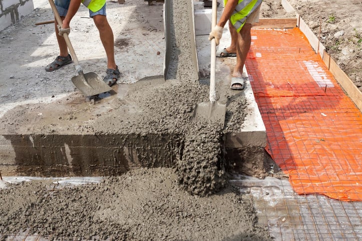 workers pouring ready-mix concrete after earning a concrete industry management degree in a science degree program for diverse career opportunities 