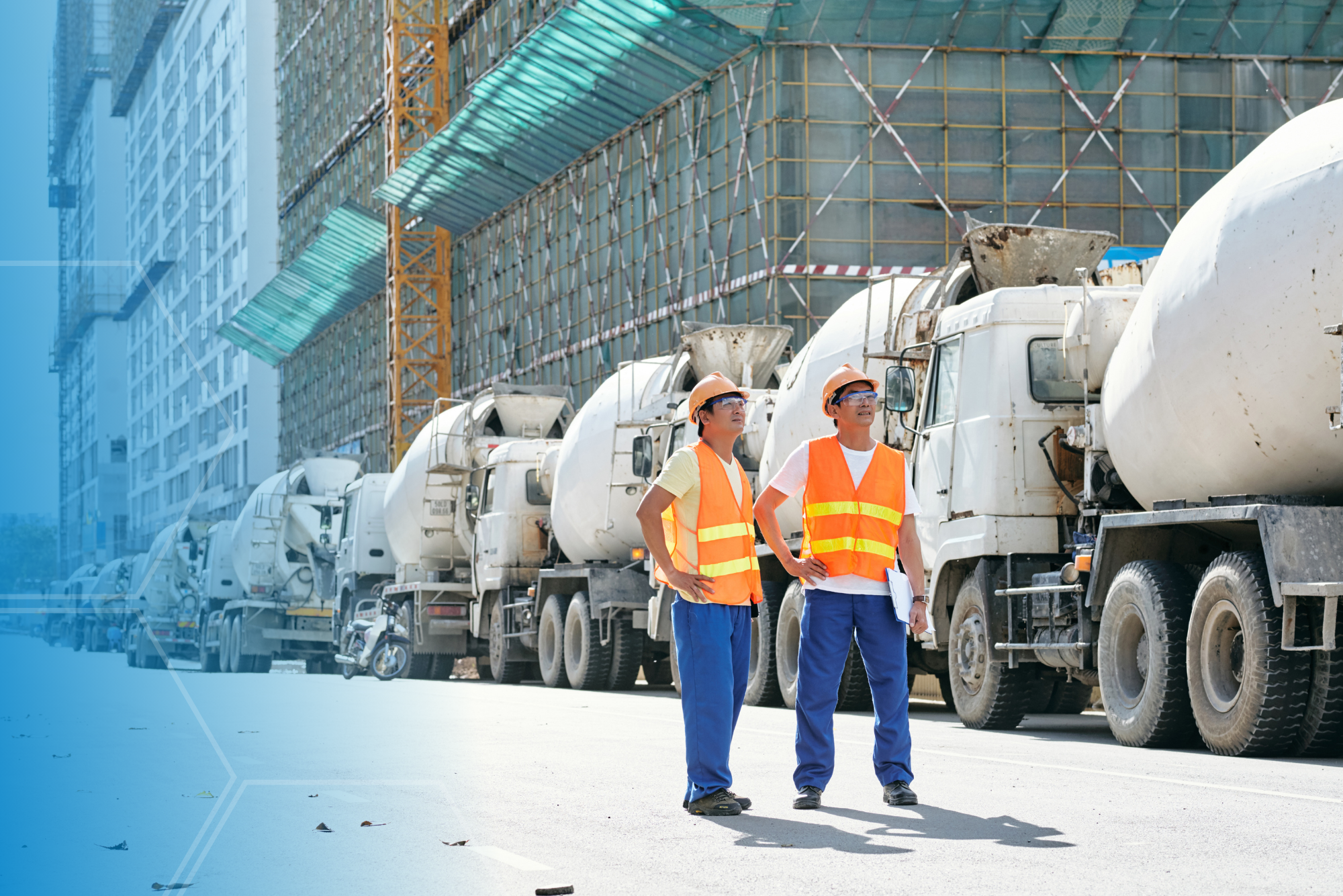 Two men by some concrete trucks